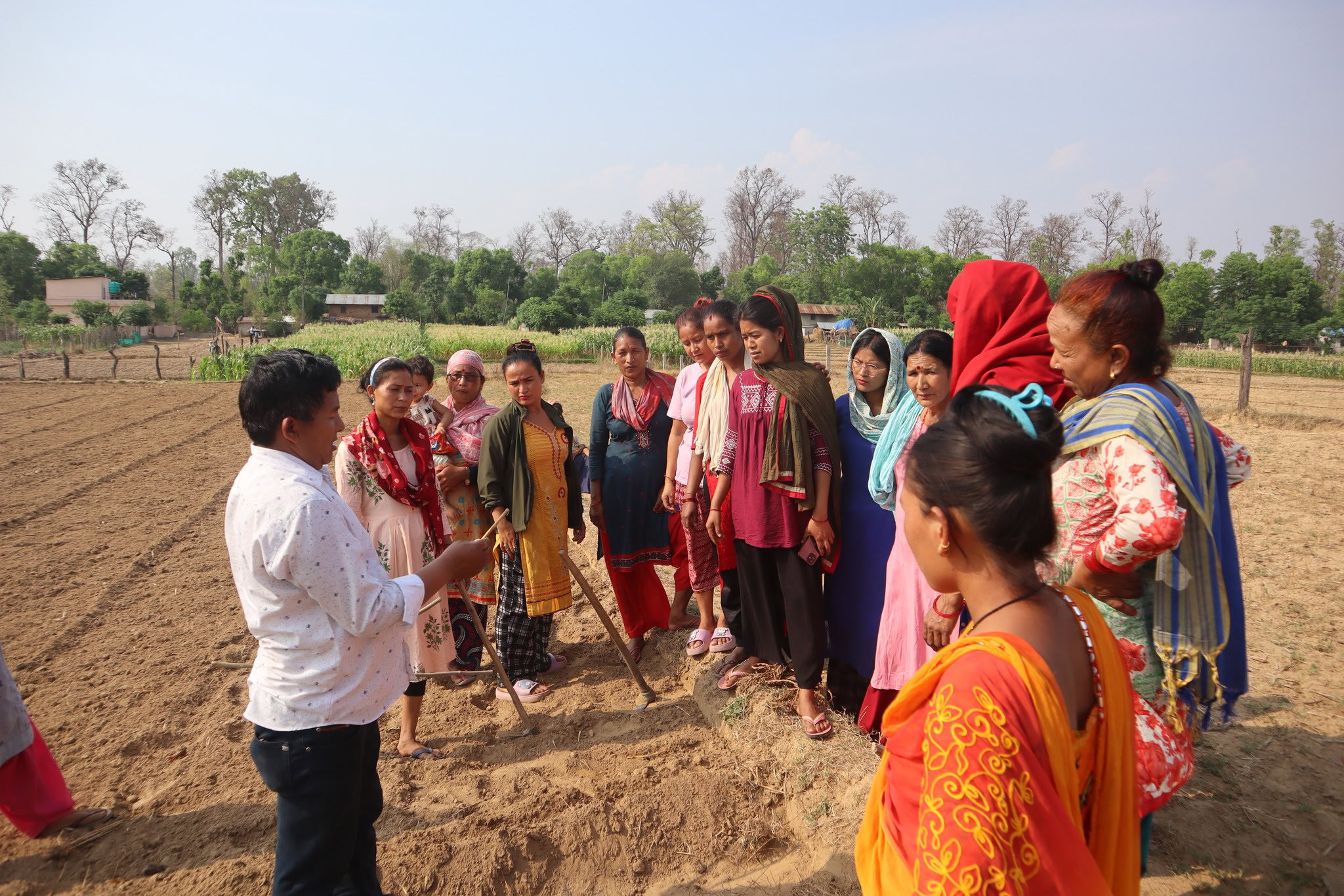 women learning to plant alternate crops at edge of Bardiya national park